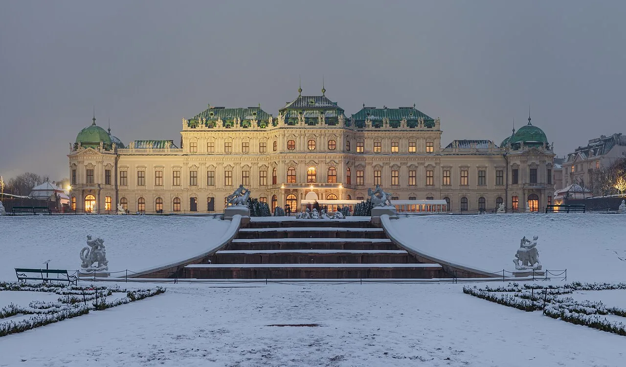 Upper Belvedere palace in Vienna under winter snow at dusk